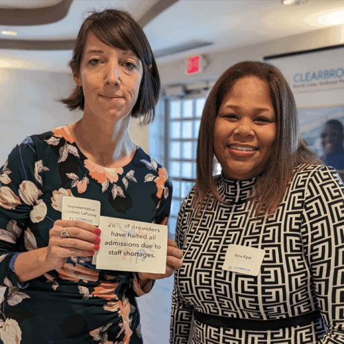 Advocates hold sign regarding staffing shortages