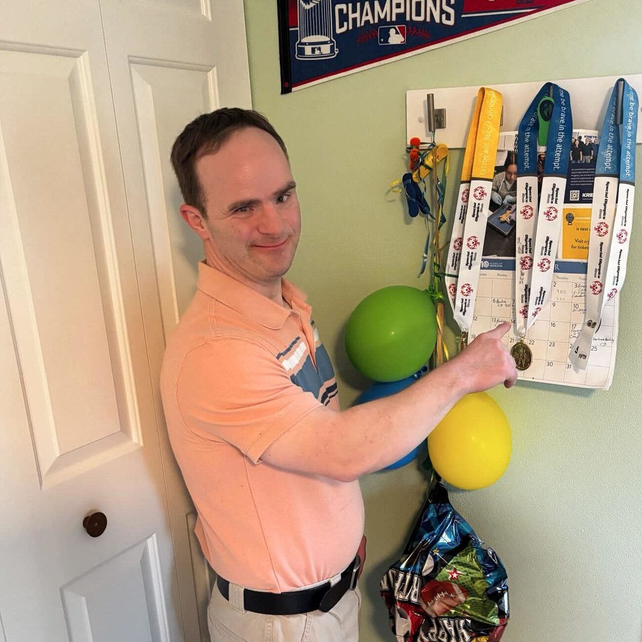Kevin shows his gymanstics medals on display in his room